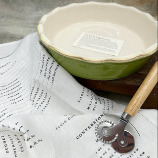 You can't go wrong with an essential baking piece from Vietri. This apple green pie dish is paired with an essential linen kitchen towel that also serves as a reference guide for kitchen conversions. Also included is a wooden handled pastry cutter to help with those homemade pie crusts. 