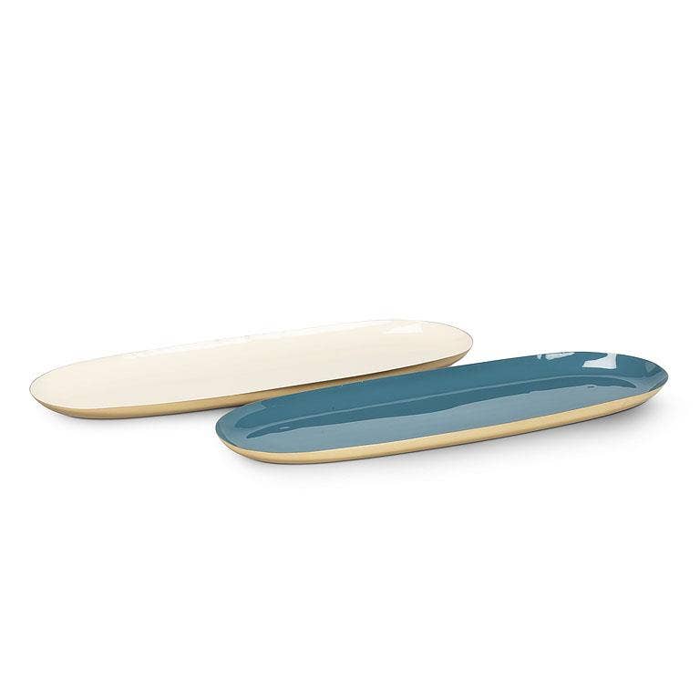 Two long oval ceramic serving platters on a white background, one glossy cream and one glossy teal blue with a cream rim.
