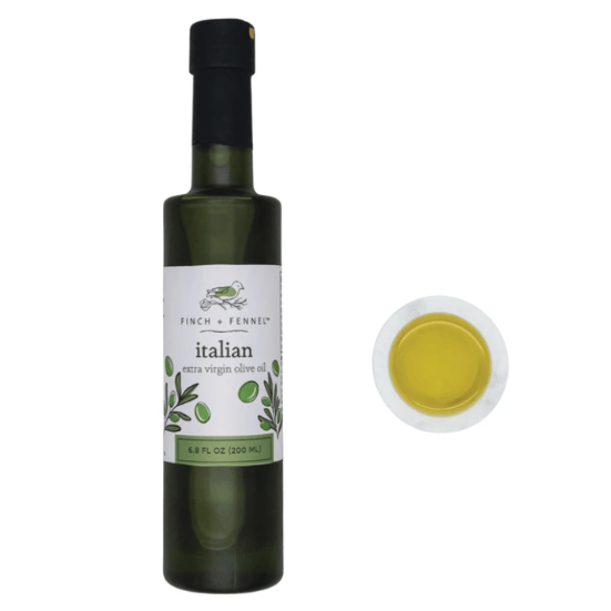 Bottle of Italian extra virgin olive oil with a close-up of the oil on a white background