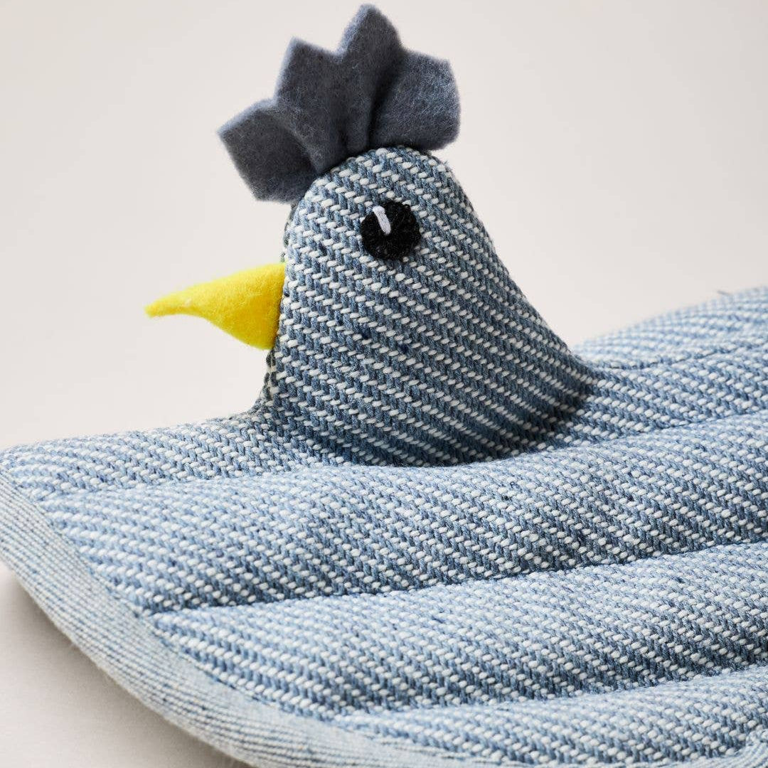 Blue denim hen potholder on a light gray background