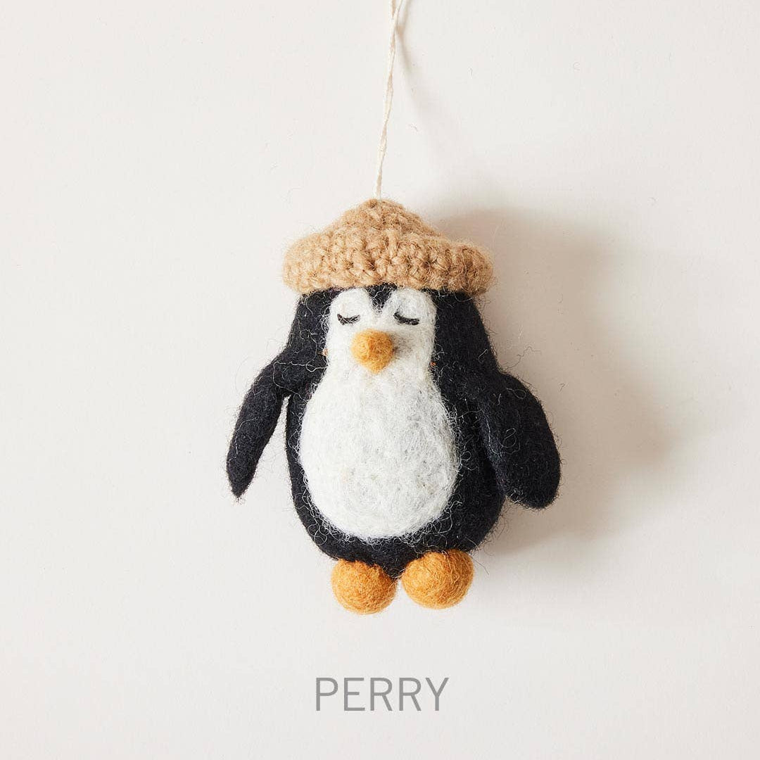 Knitted penguin ornament with a hat on a white background