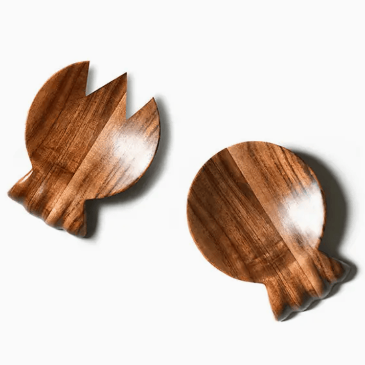 Set of acacia wood salad servers with ruffled handle on white background
