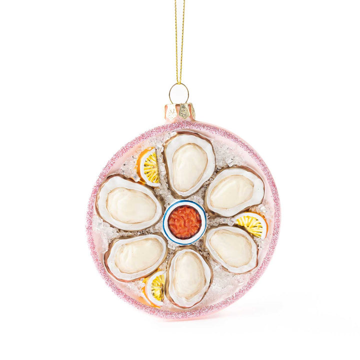 Decorative ornament resembling a plate of oysters with garnishes on a white background