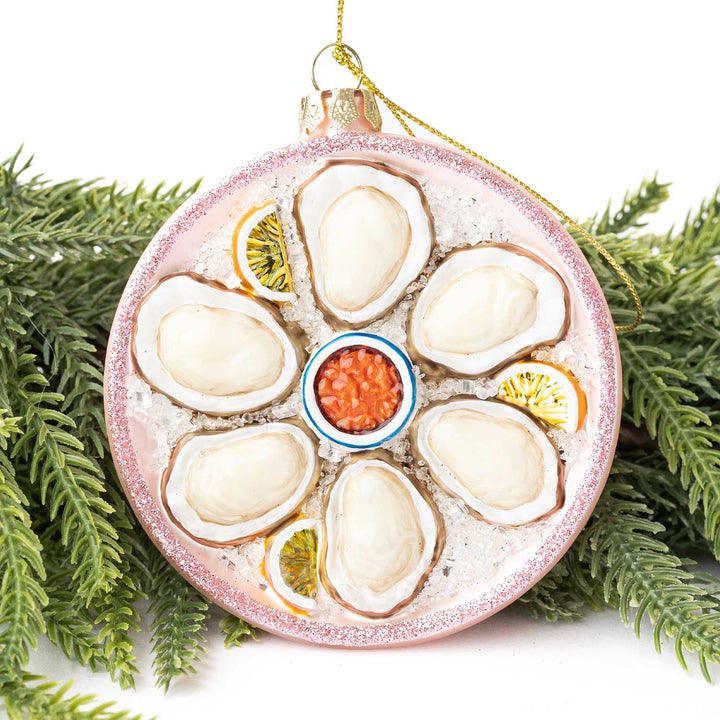 Decorative ornament resembling a plate of oysters with garnishes on a white background
