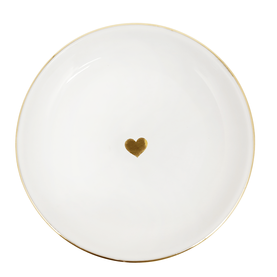 White plate with a gold heart on a green background