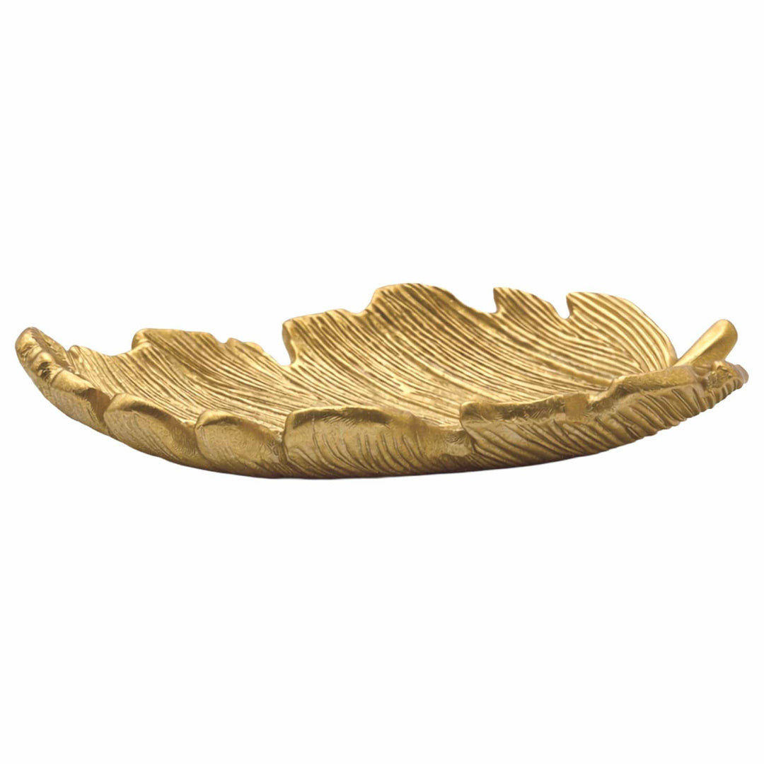 A gold-toned decorative tray shaped like a leaf, featuring textured ridges and a shallow bowl, shown against a plain white background.