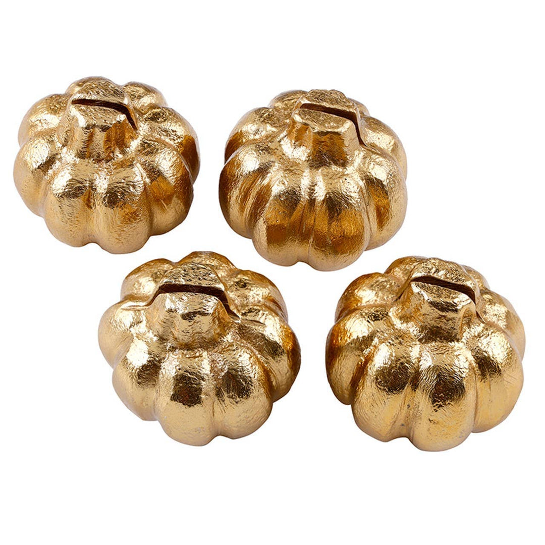 Four gold pumpkin-shaped objects on a white background