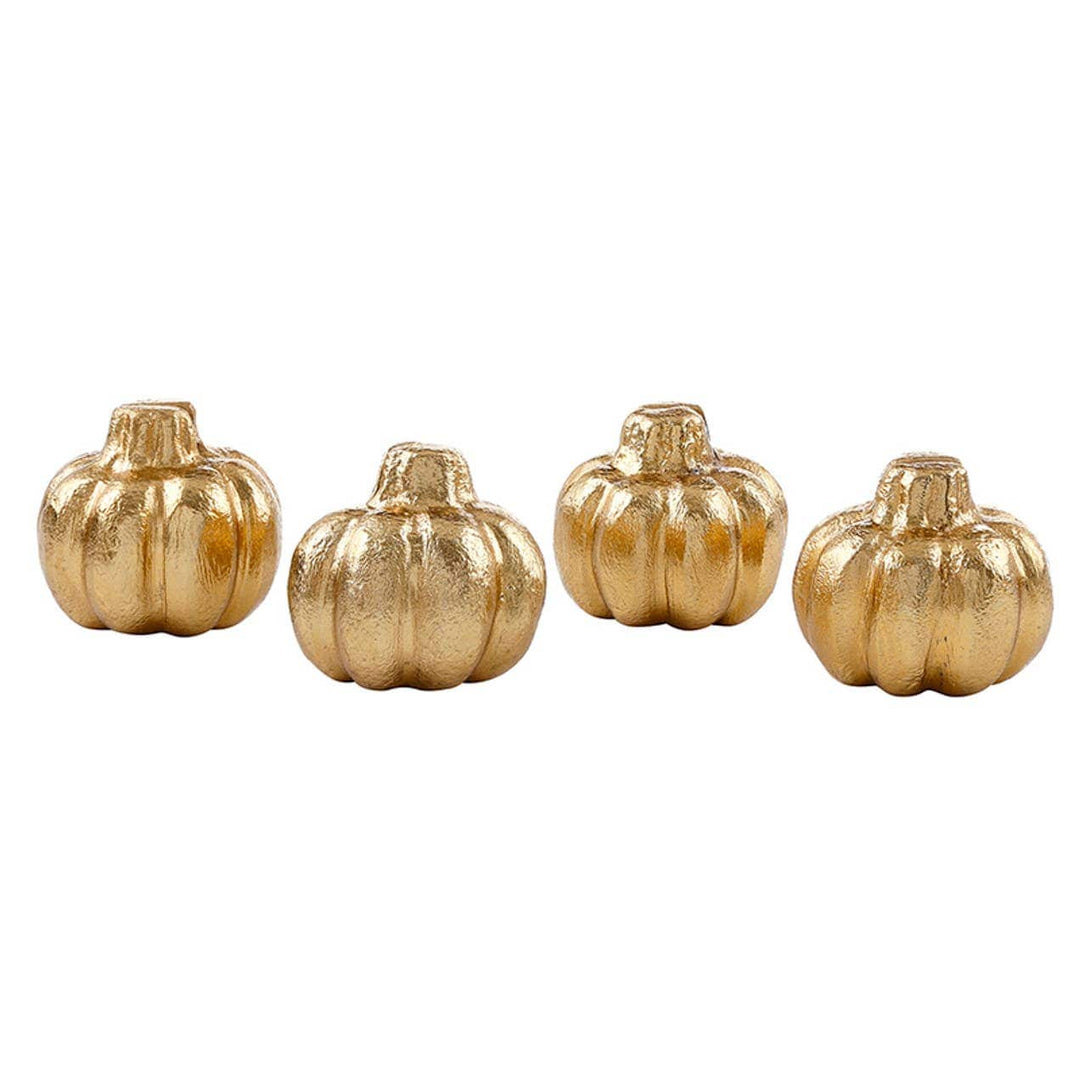 Set of four gold pumpkin-shaped containers on a white background