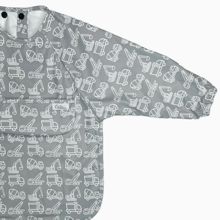 gray long sleeved bib with construction trucks pattern