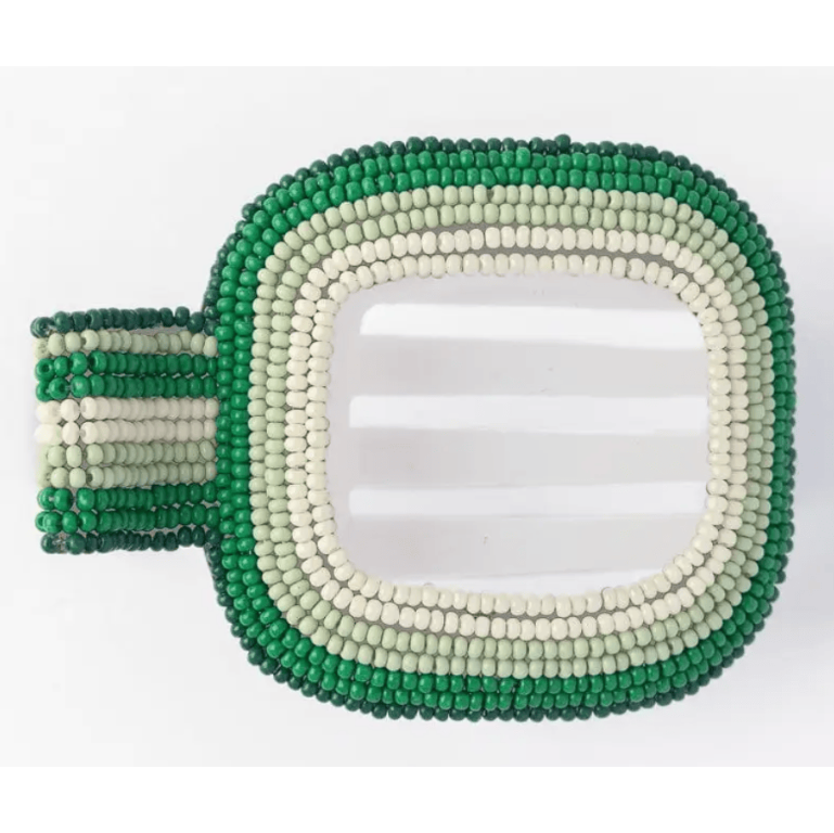 Beaded hair clip with green and white beads on a white background