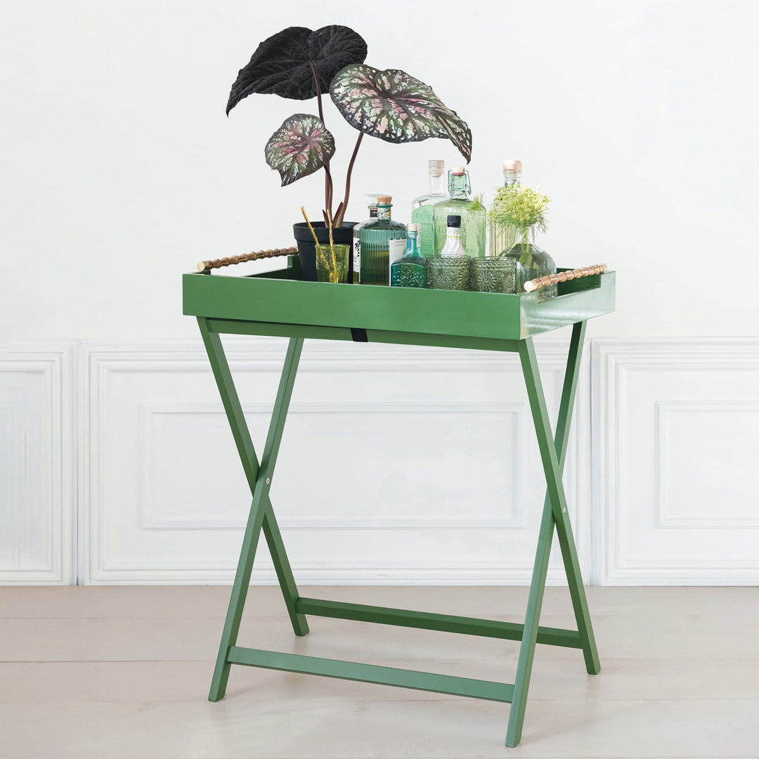 Green tray table with decorative items on a white background