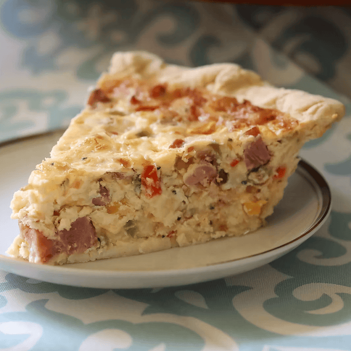 Slice of pie on a plate with a patterned tablecloth