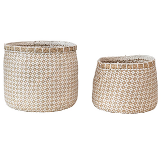 These unique and artful, hand-woven seagrass and paper baskets have an ornate pattern and come in a set of two. This set will be a natural and functional accent for almost any room in your home or office. 