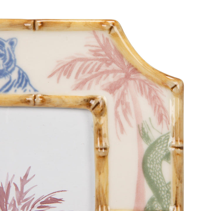 Decorative glass panel with bamboo frame and floral patterns on a white background