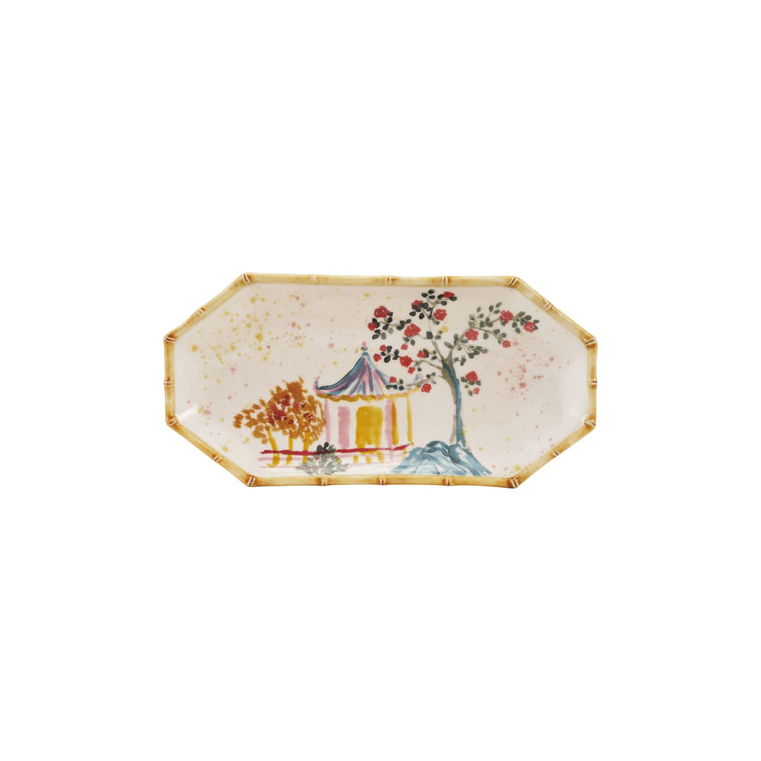 Decorative plate with a scenic design of a pagoda and tree on a white background