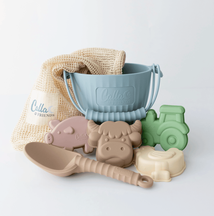 Set of children's play utensils including a blue bucket, animal-shaped molds, and a scoop on a light gray background.