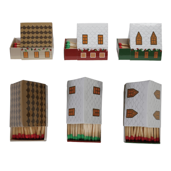 Six miniature house-shaped matchboxes arranged in two rows on a plain white background. Each matchbox has a different roof design printed on the lid, and the matchsticks inside are visible at the bottom.