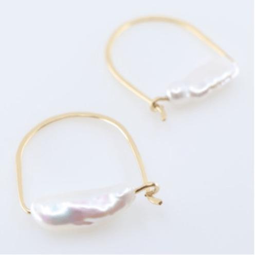 Gold hoop earrings with large pearl-like stones on a white background