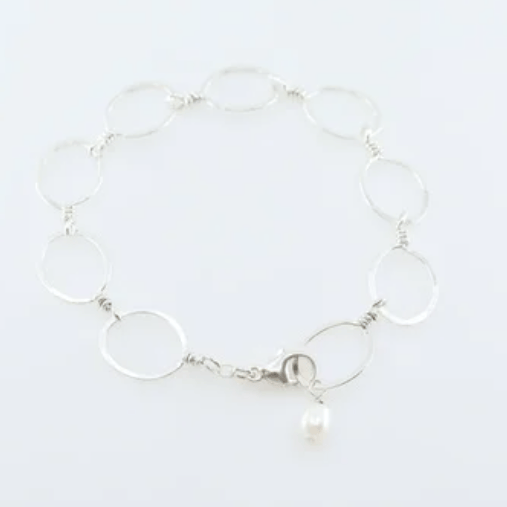 Forged 14K gold filled oval link bracelet with forged clasp and pearl accent on white background.