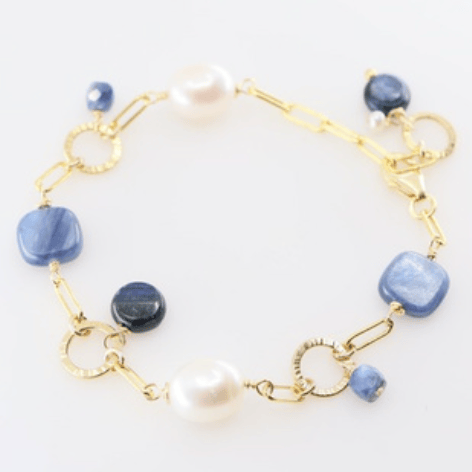 Bracelet with square blue kyanite stones and large rice pearls and gold filled hammered links on white background.