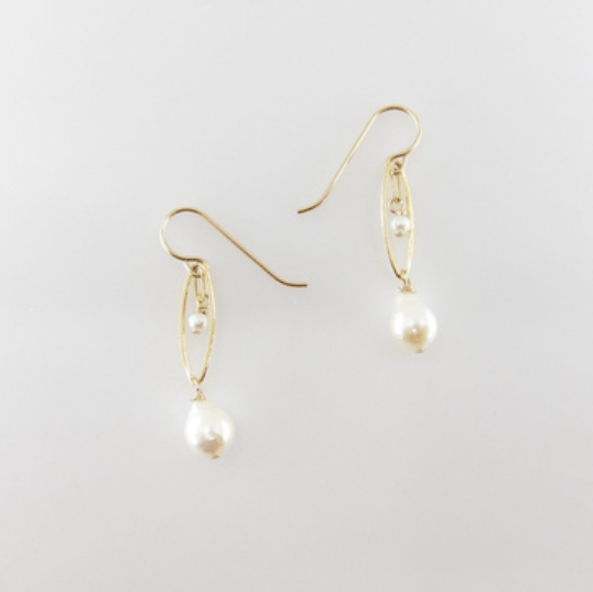 Pair of pearl earrings on a light gray background