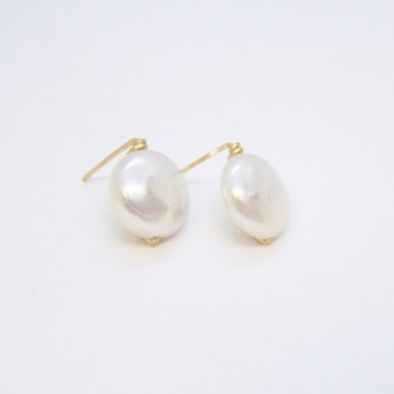 Pair of pearl earrings on a light gray background