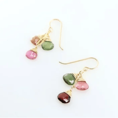 Gold earrings with multicolored gemstones on a white background