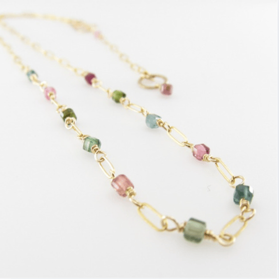 14K Gold Filled paperclip chain necklace with 11 tiny faceted watermelon tourmaline gemstone cubes on white background.