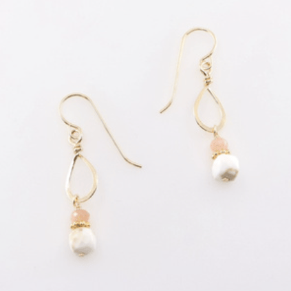 Gold earrings with pearl drops on a white background