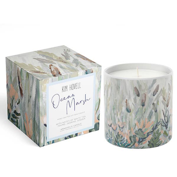 Candle with decorative packaging featuring ocean-themed design