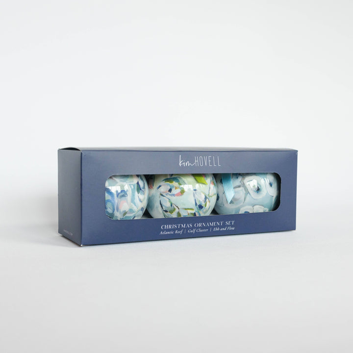 Box of Christmas ornaments with floral design on a white background