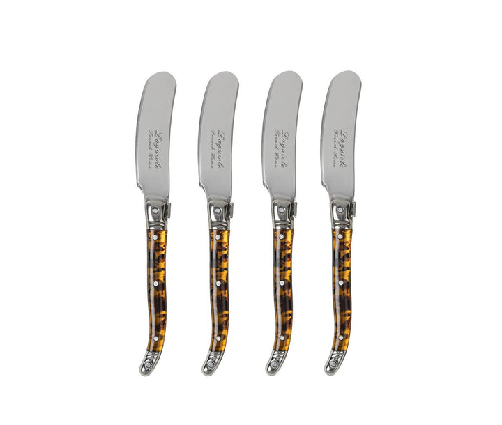 Set of four cheese spreaders with tortoiseshell handles on a white background