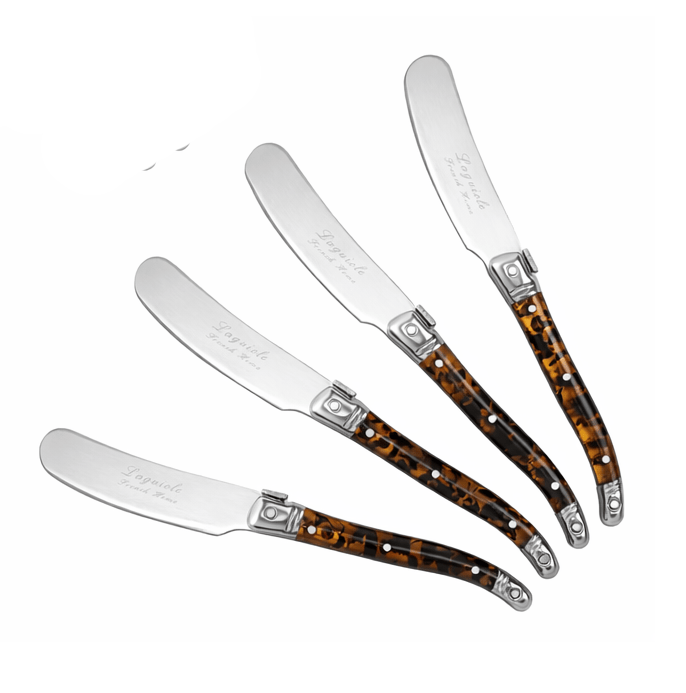 Set of four cheese spreaders with tortoiseshell handles on a white background