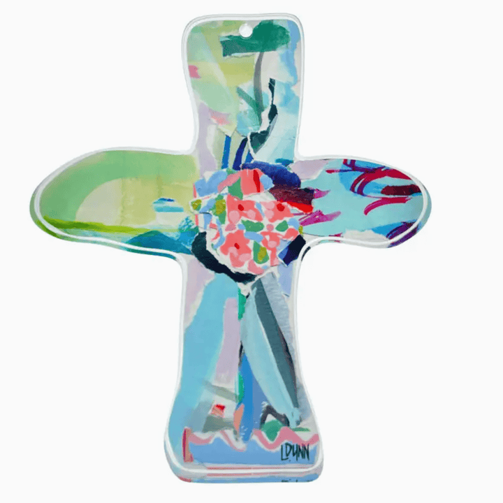 Colorful cross-shaped object with artistic design on a white background