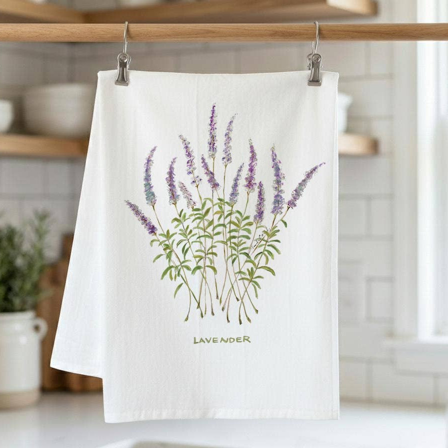 White towel with lavender design hanging on a rack in a kitchen.