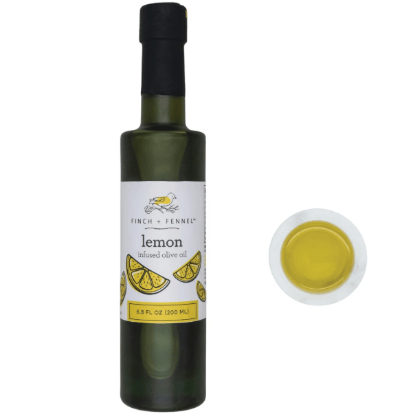 Bottle of lemon infused olive oil on white background.