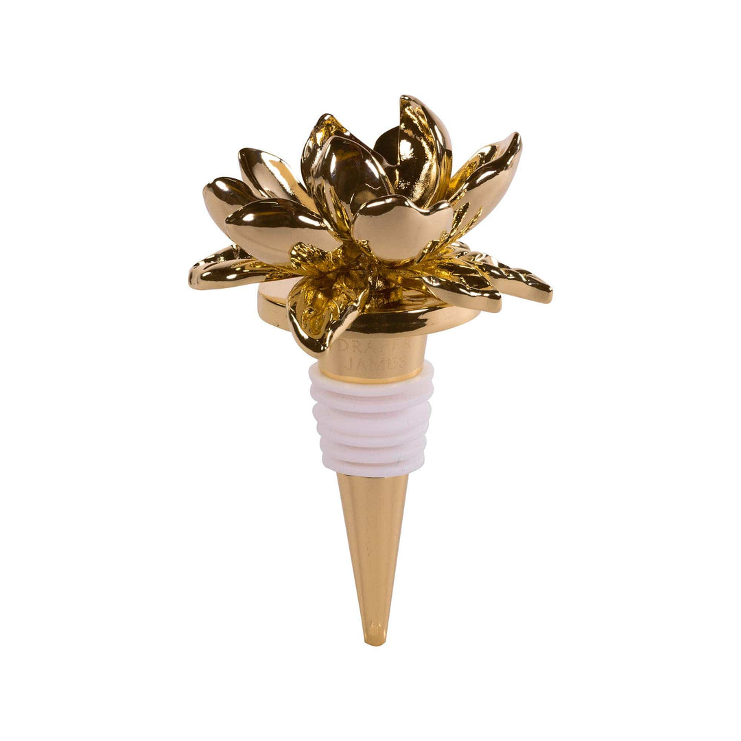 Gold magnolia flower bottle stopper on a white background