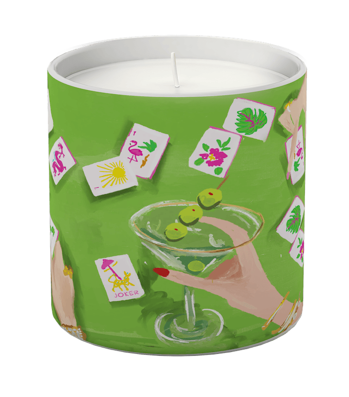 Candle in a green container with a cocktail and card design on a white background