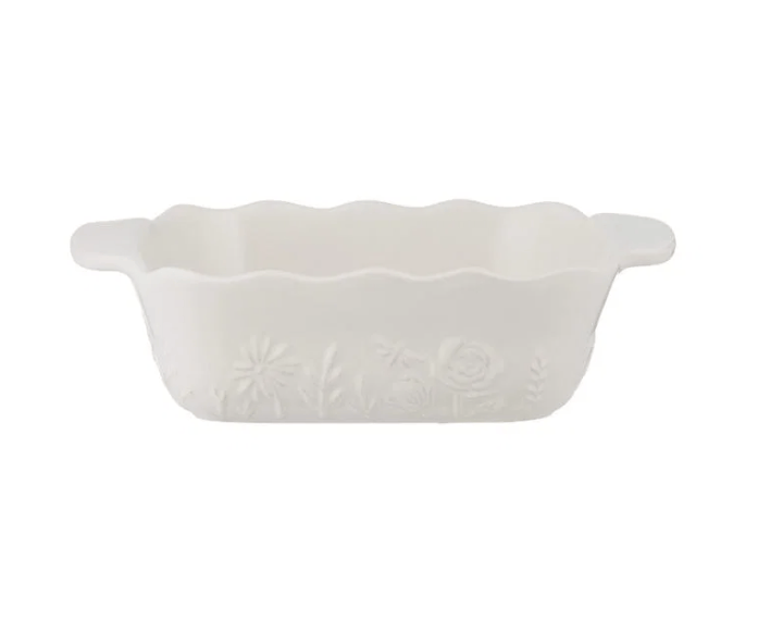 A white rectangular baking dish with scalloped edges and small embossed floral patterns, shown on a plain white background.