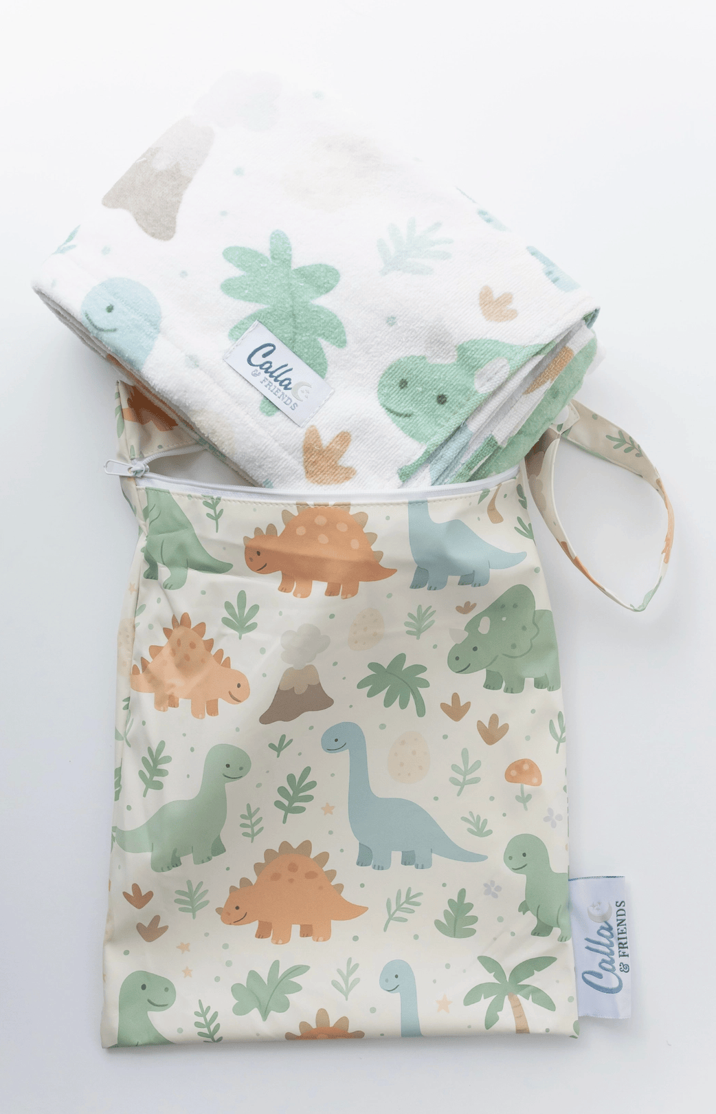 Baby blanket with dinosaur pattern and matching pouch on a white background
