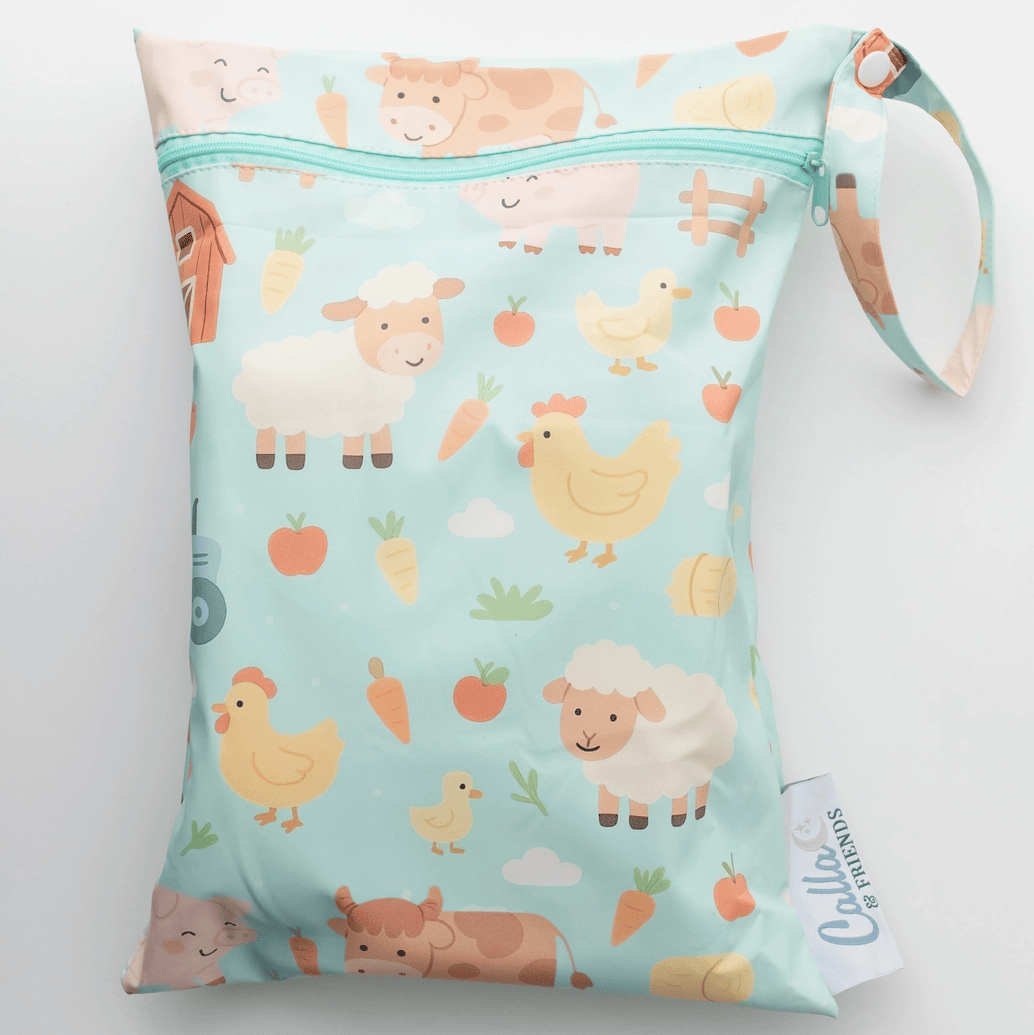 Wet bag with farm animal pattern on a light blue background