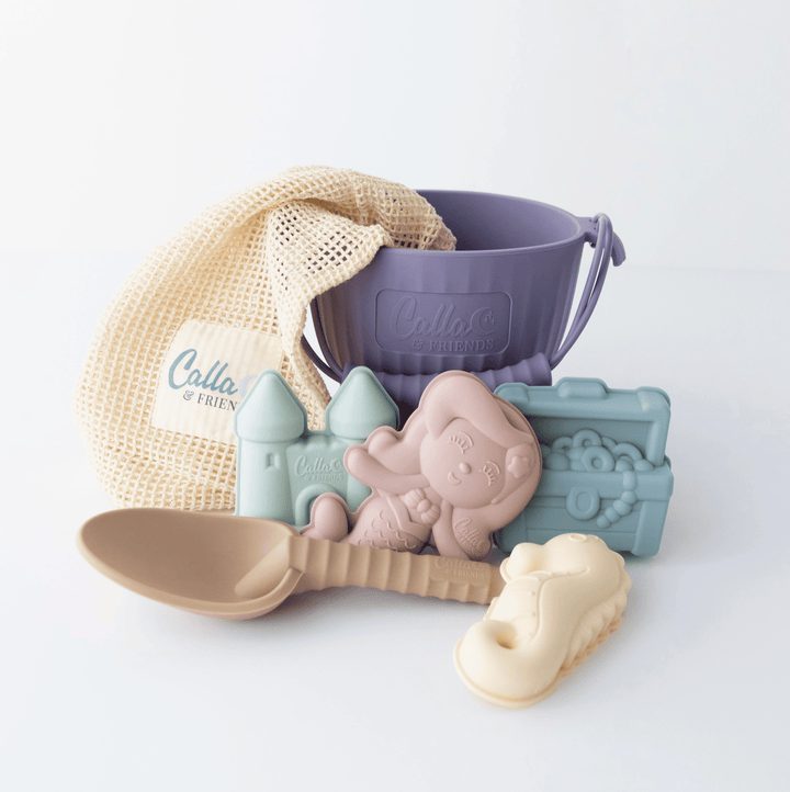 Set of baby toys including a spoon, castle, and animal-shaped molds on a white background.