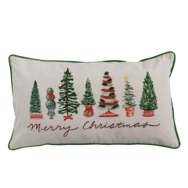 White lumbar pillow with green piping, assorted Christmas trees and merry Christmas in script.