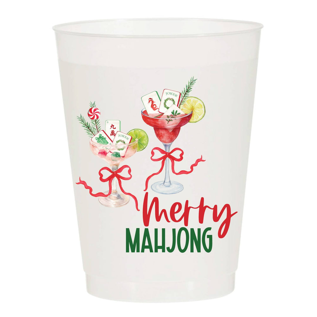 Clear plastic cup with 'Merry Mahjong' design featuring cards, a cocktail, and festive elements on a white background.