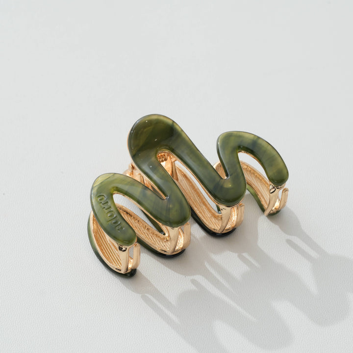 Jade Green and gold claw hair clip on a light gray background