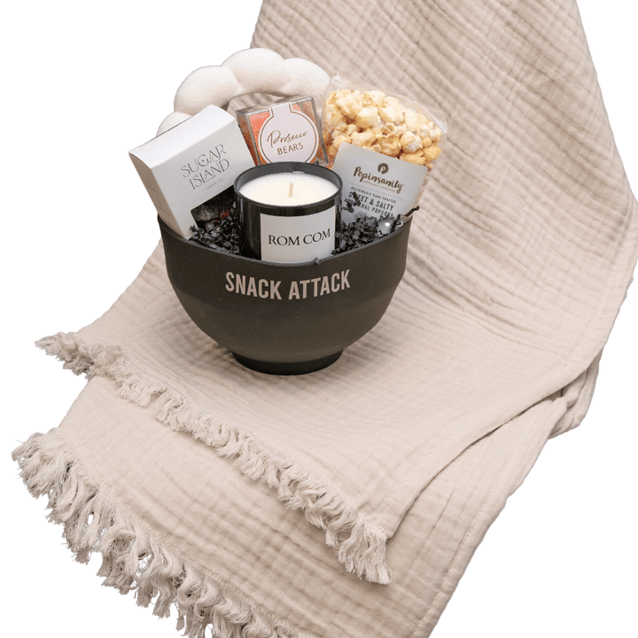 Silicone popcorn bowl filled with Rom Com candle, terry head band, cozy socks, prosecco gummies, popcorn, trail mix