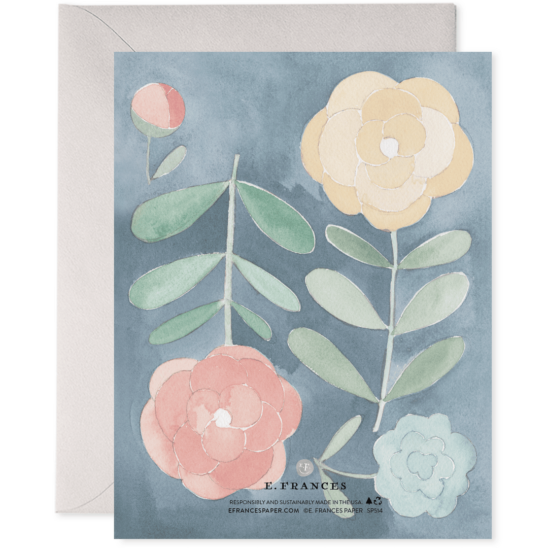 Floral card with watercolor flowers and leaves on a blue background, featuring the brand 'E. Frances'.