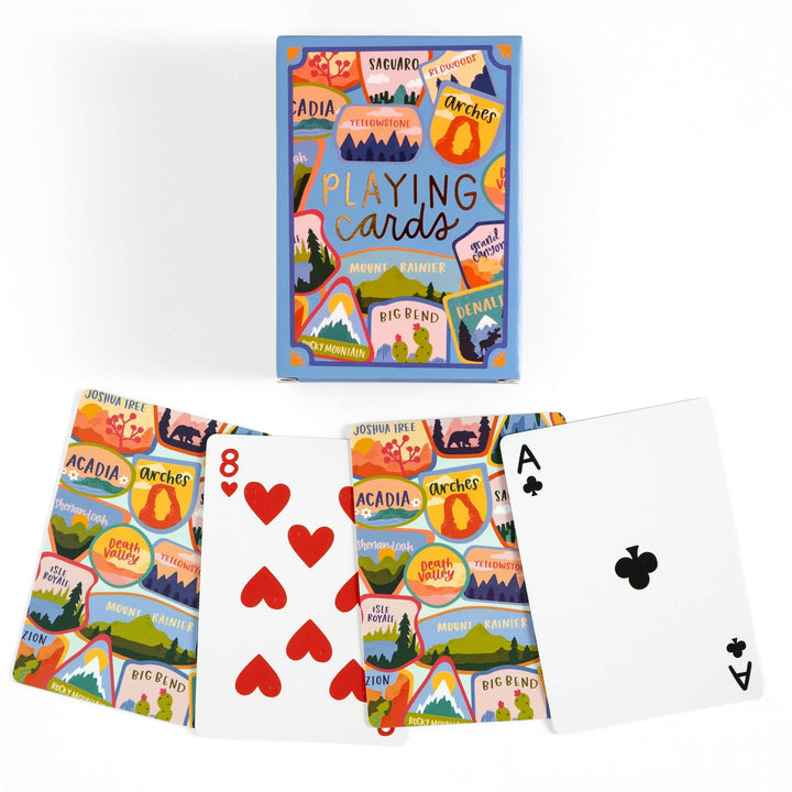 Playing cards with national park designs and a deck of cards displayed.