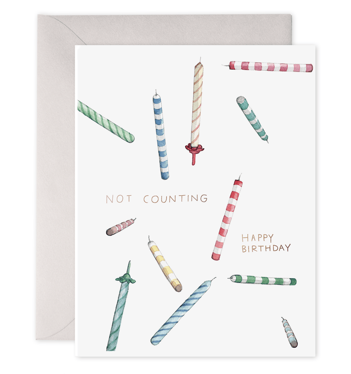 Birthday card with colorful candles and text 'Not Counting Happy Birthday' on a white background.