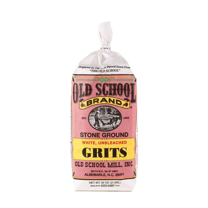 A 20 oz bag of Old School Brand Stone Ground White, Unbleached Grits, featuring a pink and yellow label on a white background.